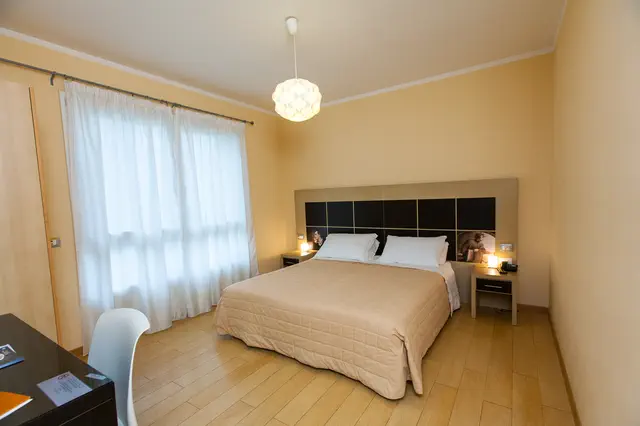 Bright Superior room with white curtains and a wooden floor